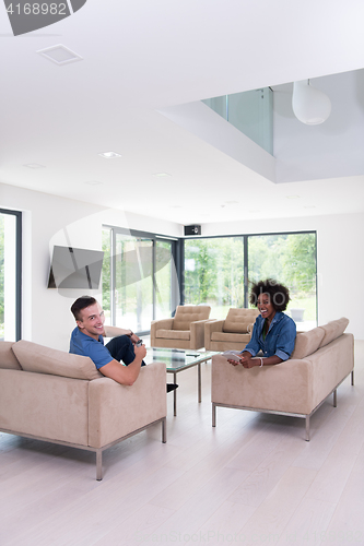 Image of multiethnic couple in living room