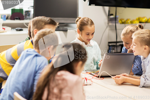 Image of happy children with laptop at robotics school