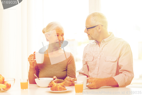 Image of happy senior couple having breakfast at home