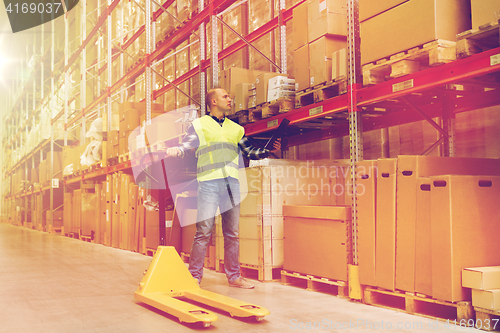 Image of man with loader and clipboard at warehouse