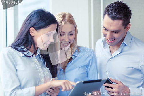 Image of business team working with tablet pcs in office