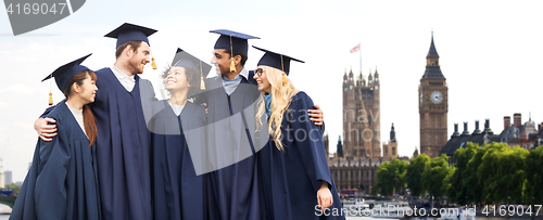 Image of happy students or bachelors over london