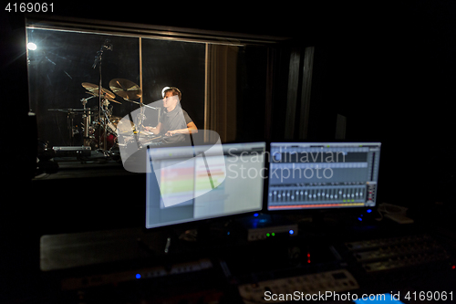 Image of man playing drum kit at sound recording studio