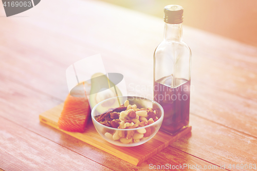 Image of close up of food and olive oil bottle on table