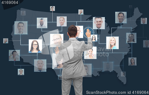 Image of businessman touching virtual screen with contacts