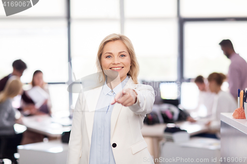 Image of smiling businesswoman at office