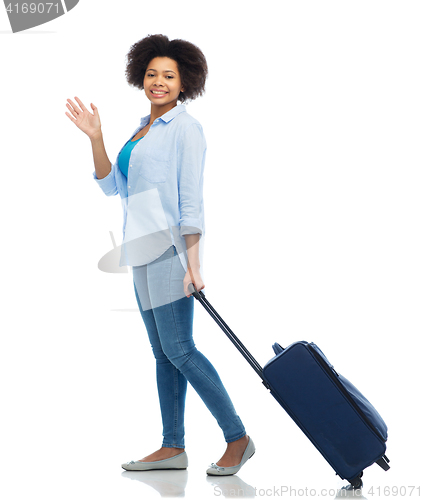 Image of happy woman with travel bag waving hand