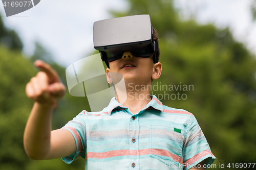 Image of boy with virtual reality headset outdoors