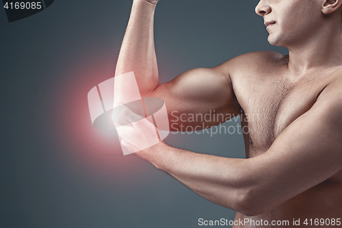 Image of Man With Pain In Elbow. Pain relief concept