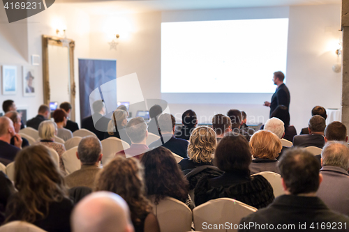 Image of Public speaker giving talk at Business Event.