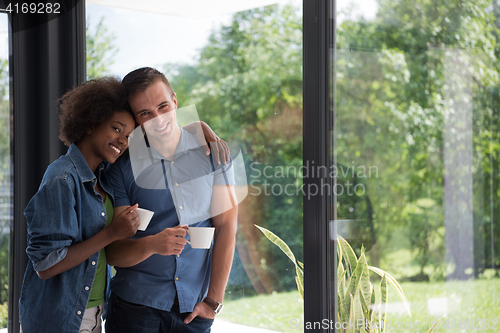 Image of romantic happy young couple relax at modern home indoors
