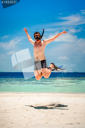 Image of Funny man jumping in flippers and mask.