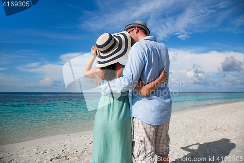 Image of Vacation Couple walking on tropical beach Maldives.