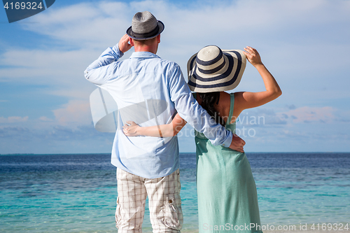 Image of Vacation Couple walking on tropical beach Maldives.