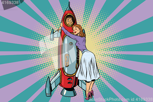 Image of Wife hugs her husband astronaut in the rocket
