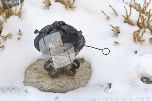 Image of Holy water shell at a grave   