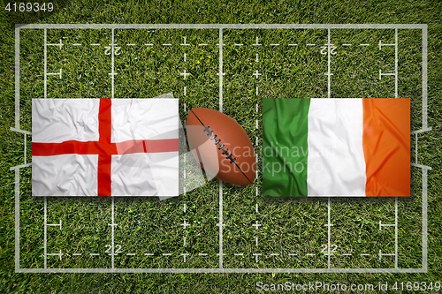 Image of England vs. Ireland\r flags on rugby field