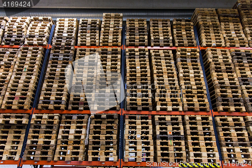 Image of wooden cargo pallets storing at warehouse shelves