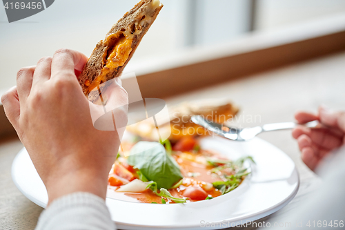 Image of close up of woman eating soup with sandwich