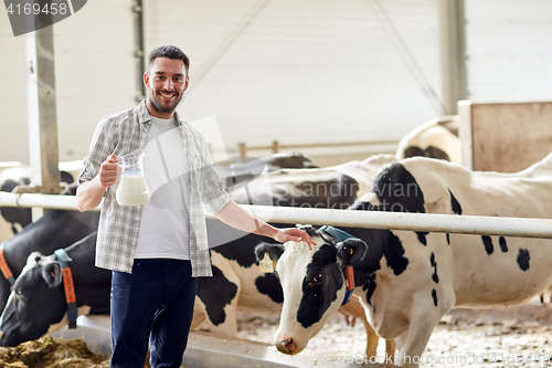 Image of man or farmer with cows milk on dairy farm