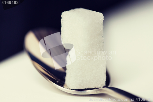 Image of close up of white sugar cubes on teaspoon