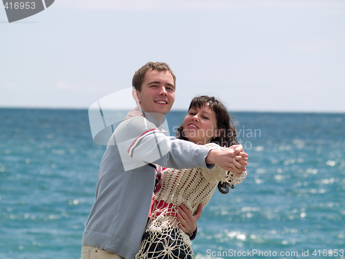 Image of Young Couple Dancing on Beach
