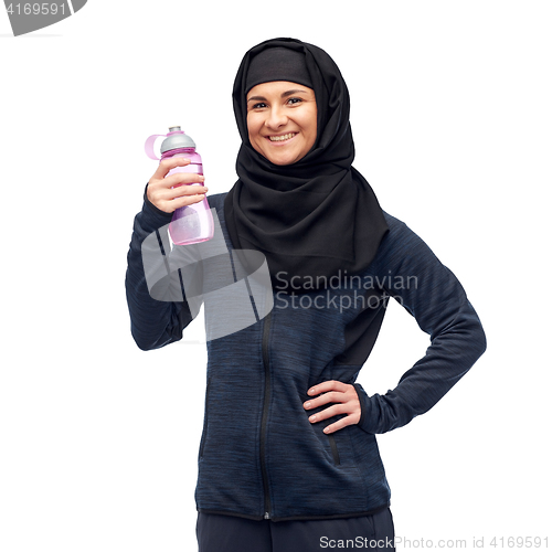 Image of muslim woman with water bottle doing sport