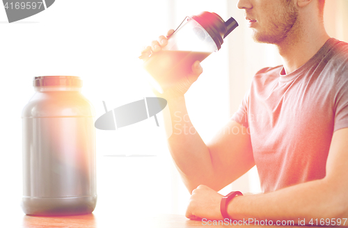 Image of close up of man drinking protein shake