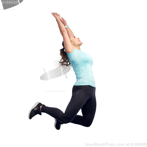 Image of happy smiling sporty young woman jumping in air