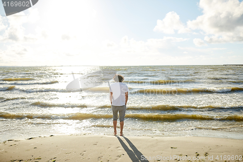 Image of young man at sea summer beach