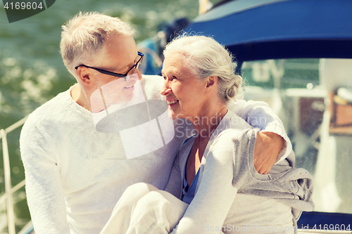 Image of senior couple hugging on sail boat or yacht in sea