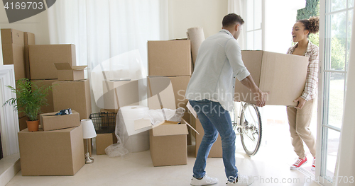 Image of Happy young couple moving into a new house