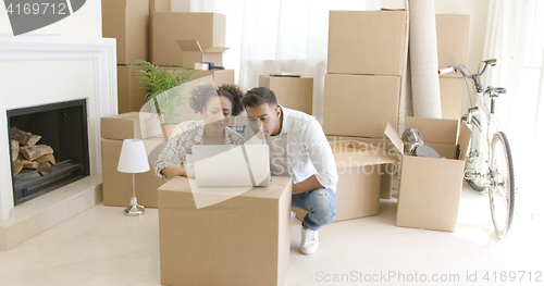 Image of Young black couple moving into their new home