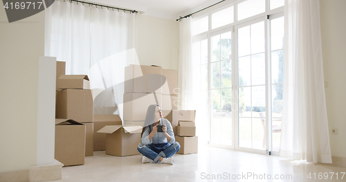 Image of Young woman starting a new life in a new home