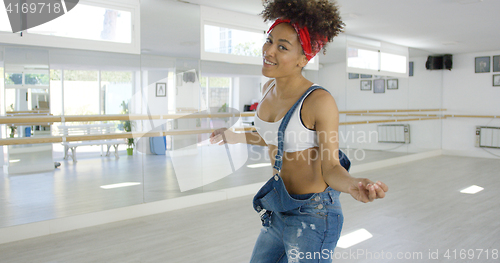 Image of Attractive female dance student smiles at camera