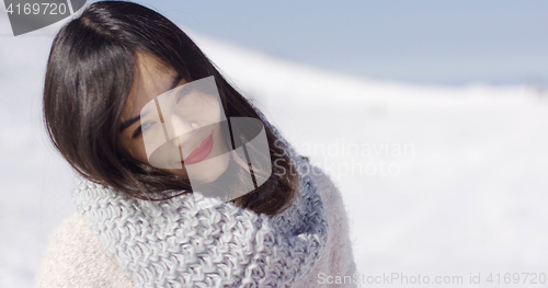 Image of Happy cute asian girl enjoying her winter time