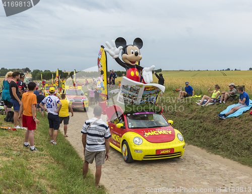 Image of Mickey Mouse Caravan on a Cobblestone Road- Tour de France 2015