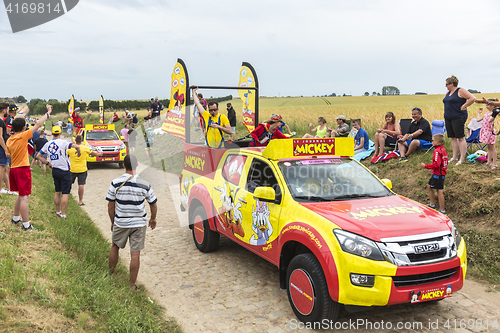 Image of Le Journal de Mickey Caravan on a Cobblestone Road- Tour de Fran