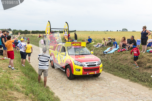 Image of Le Journal de Mickey Vehicle on a Cobblestone Road- Tour de Fran