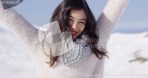 Image of Happy young asian girl enjoys snowy winter