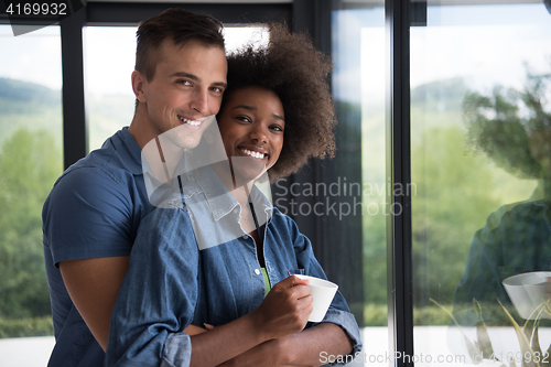 Image of romantic happy young couple relax at modern home indoors