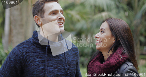 Image of Loving young couple looking up into the air
