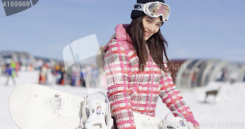 Image of Young smiling woman with ski boots