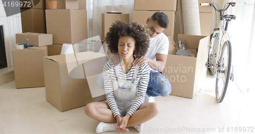 Image of Man doing her girlfriend massage of the neck