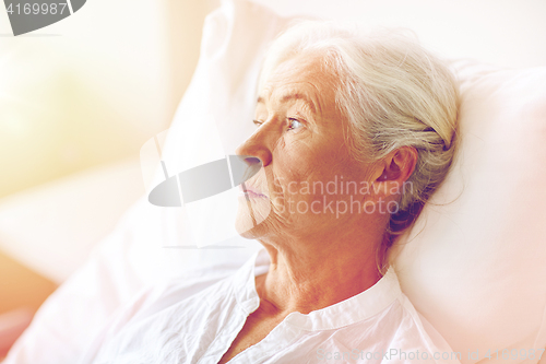 Image of senior woman patient lying in bed at hospital ward