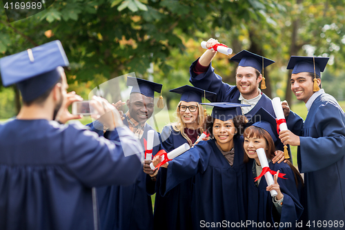 Image of students or bachelors photographing by smartphone