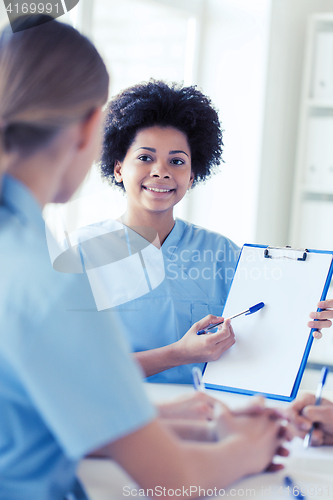 Image of group of happy doctors meeting at hospital office