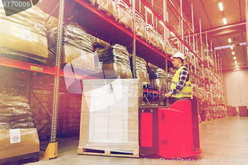 Image of man on forklift loading cargo at warehouse