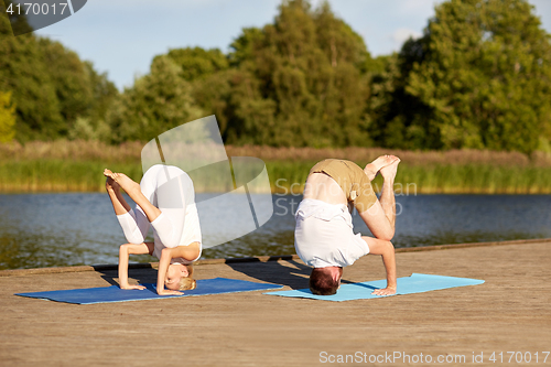 Image of couple making yoga outdoors