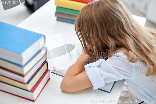 Image of close up of student girl with many books at school